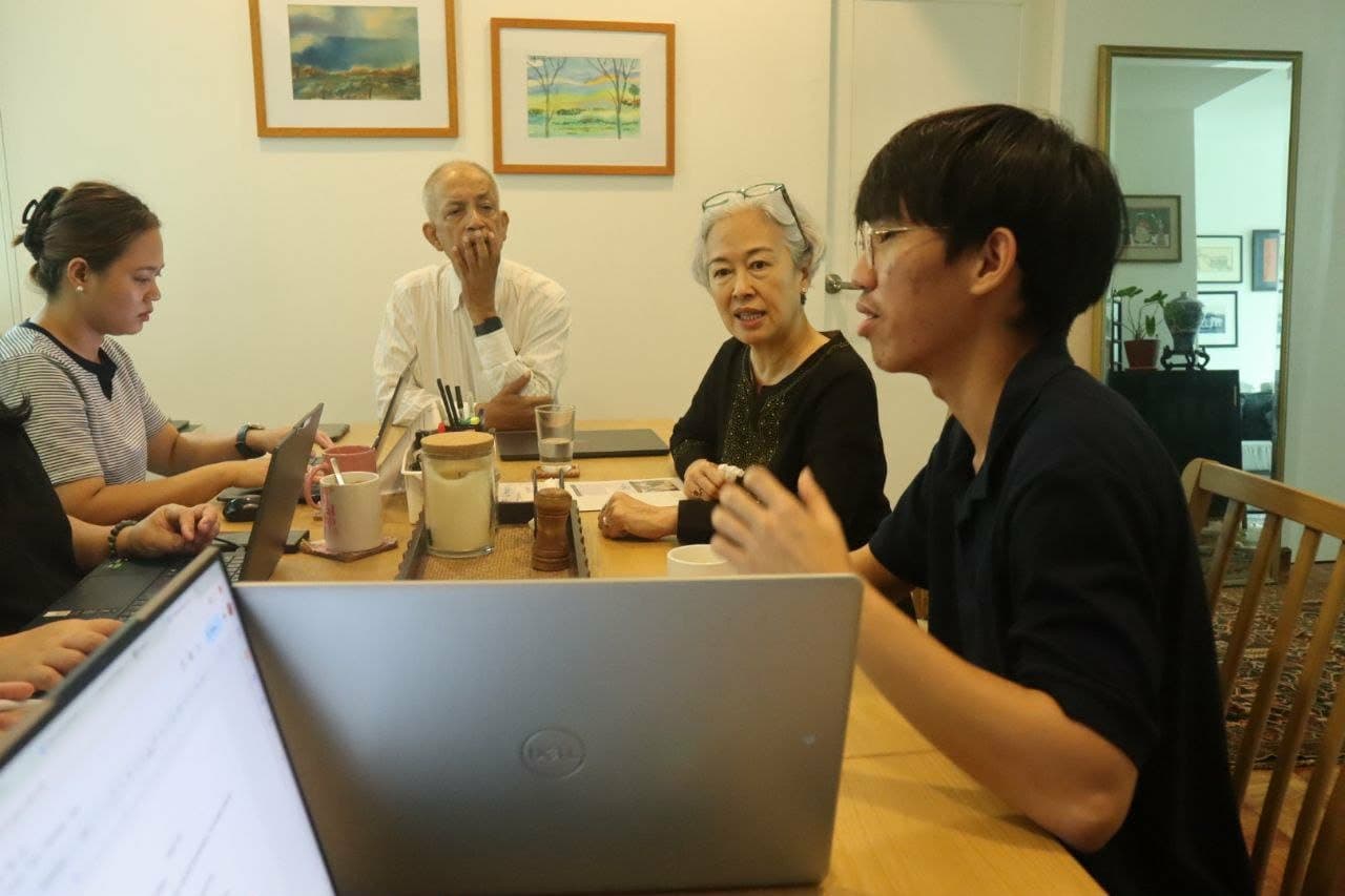 Client scoping session around a table with laptops open